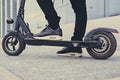 Cropped image of a man on an electric scooter. Royalty Free Stock Photo