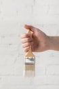 Man holding brush in white paint Royalty Free Stock Photo