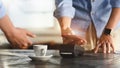 Cropped image of man using a smartphone for making a bill payment at credit card reader. Royalty Free Stock Photo