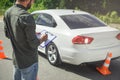 cropped image of man writing something to car insurance