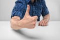 Cropped image of masculine hands showing thumbs up.