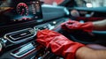 Cropped image of mature male worker cleaning car dashboard.