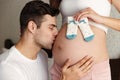 Cropped image of man kissing belly of his lovely pregnant wife Royalty Free Stock Photo