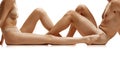 Cropped image of men& x27;s and women& x27;s bare legs against white studio background. Hair removal concept.