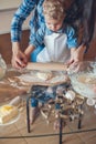 cropped image of mother and son rolling dough Royalty Free Stock Photo