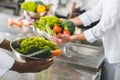 cropped image of multicultural chefs holding bowls with vegetables