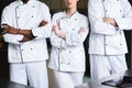 cropped image of multicultural chefs standing with crossed arms