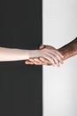 cropped image of multicultural couple holding hands near black Royalty Free Stock Photo