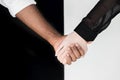 cropped image of multicultural couple holding hands, yin Royalty Free Stock Photo