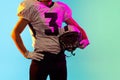 Cropped image of one American football player in sports equipment helmet and gloves isolated on dark studio background Royalty Free Stock Photo