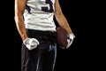Cropped image of one American football player in sports equipment helmet and gloves isolated on dark studio background Royalty Free Stock Photo