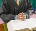 Cropped photo of pastor praying in church