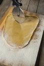 Cropped image of pastry cutter cutting dough
