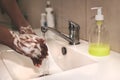 African-American woman washes hands. Cropped image of person washing hands at sink in bathroom, Coronavirus hand washing for clean