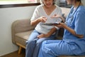 Cropped image, A positive Asian old woman visiting doctor in the hospital office Royalty Free Stock Photo