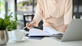 Cropped image of a professional Asian businesswoman examining a financial report at her desk Royalty Free Stock Photo