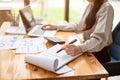 Cropped image of a professional Asian female accountant is focusing on her work Royalty Free Stock Photo