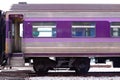 Cropped image of purple bogie of train on railway. Royalty Free Stock Photo