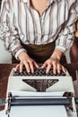 cropped image of retro styled african american journalist typing at typewriter Royalty Free Stock Photo