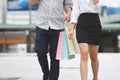 Cropped image of romance young Asian couple carrying colorful shopping bags on city street in weekend Royalty Free Stock Photo