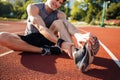 Cropped image of a runner suffering from leg cramp Royalty Free Stock Photo