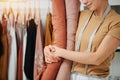 Cropped image of a seamstress hugging rolls of fabric Royalty Free Stock Photo