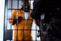 cropped image of security guard standing near prison bars Royalty Free Stock Photo