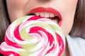 Cropped image of seductive girl biting colorful lollipop. Valentines day concept Royalty Free Stock Photo