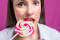 Cropped image of seductive girl biting colorful lollipop. Valentines day concept Royalty Free Stock Photo