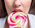 Cropped image of seductive girl biting colorful lollipop. Valentines day concept Royalty Free Stock Photo