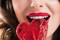 cropped image of seductive girl biting heart shaped lollipop, valentines day Royalty Free Stock Photo