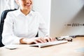 Cropped image of a smiling happy businesswoman typing on keyboard Royalty Free Stock Photo