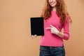 Cropped image of a smiling young redhead girl pointing Royalty Free Stock Photo