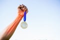 Cropped image of sportsperson holding gold medal