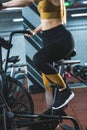 Cropped image of sportswoman doing workout on exercise bike Royalty Free Stock Photo