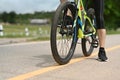 Cropped image of sporty man riding a bicycle along the bike path in a city park. Travel, sport and active lifestyle Royalty Free Stock Photo