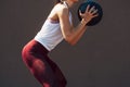 Cropped image of a sporty young woman doing exercises with a medicine ball outdoors on a sunny day. Fitness female exercising Royalty Free Stock Photo