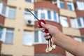 Cropped image of strong hand of real estate agent holding out house keys. Royalty Free Stock Photo