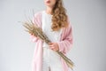 cropped image of stylish woman holding bunch of willow tree branches and spikelets