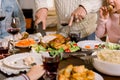 Cropped image of Thanksgiving festive table: Hands of elderly Man Carving Slices Of Roast Turkey For Dinner Royalty Free Stock Photo