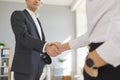 Cropped image of two business people shaking hands to confirm their partnership. Royalty Free Stock Photo