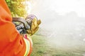 Cropped image of two pairs of hands holding the handle on the end of a firefighter`s water