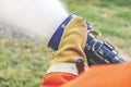 Cropped image of two pairs of hands holding the handle on the end of a firefighter`s water