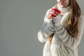 cropped image of woman in fashionable winter sweater and scarf holding cup of tea isolated Royalty Free Stock Photo