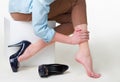 Cropped image of woman in high heels massaging her tired legs Royalty Free Stock Photo