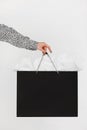 Cropped image of woman holding black shopping bag isolated. Royalty Free Stock Photo