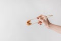 cropped image of woman holding chinese fortune cookie with chopsticks