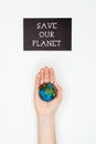 cropped image of woman holding earth model on hand under sign save our planet
