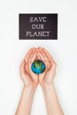 cropped image of woman holding earth model in hands under sign save our planet Royalty Free Stock Photo