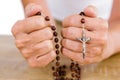 Cropped image of woman holding rosary beads Royalty Free Stock Photo